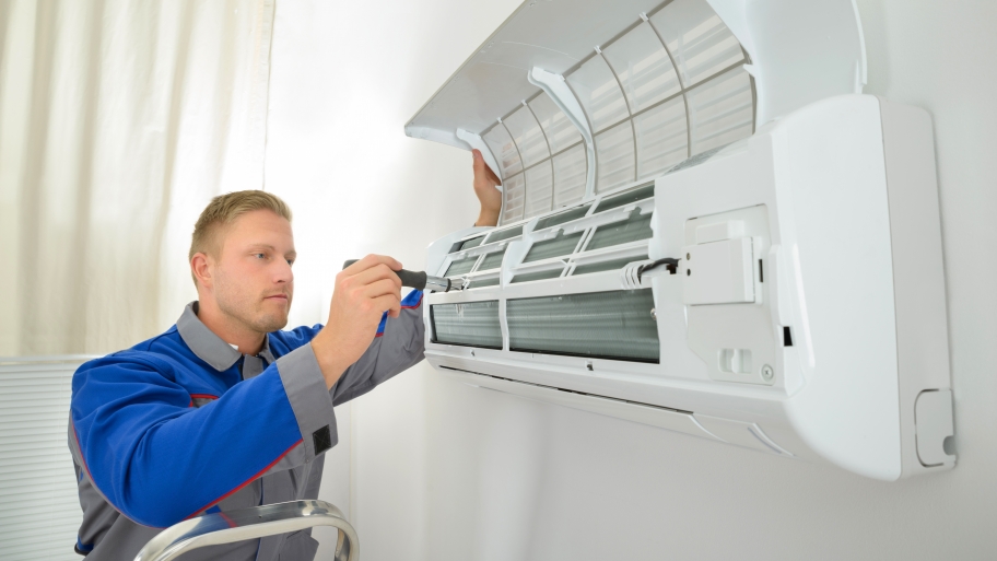 HVAC contractor working on air conditioner